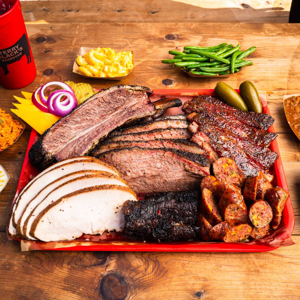 Terry Black’s Barbecue signature dishes Chopped Beef Sandwich, Sliced Brisket, Pork Ribs.